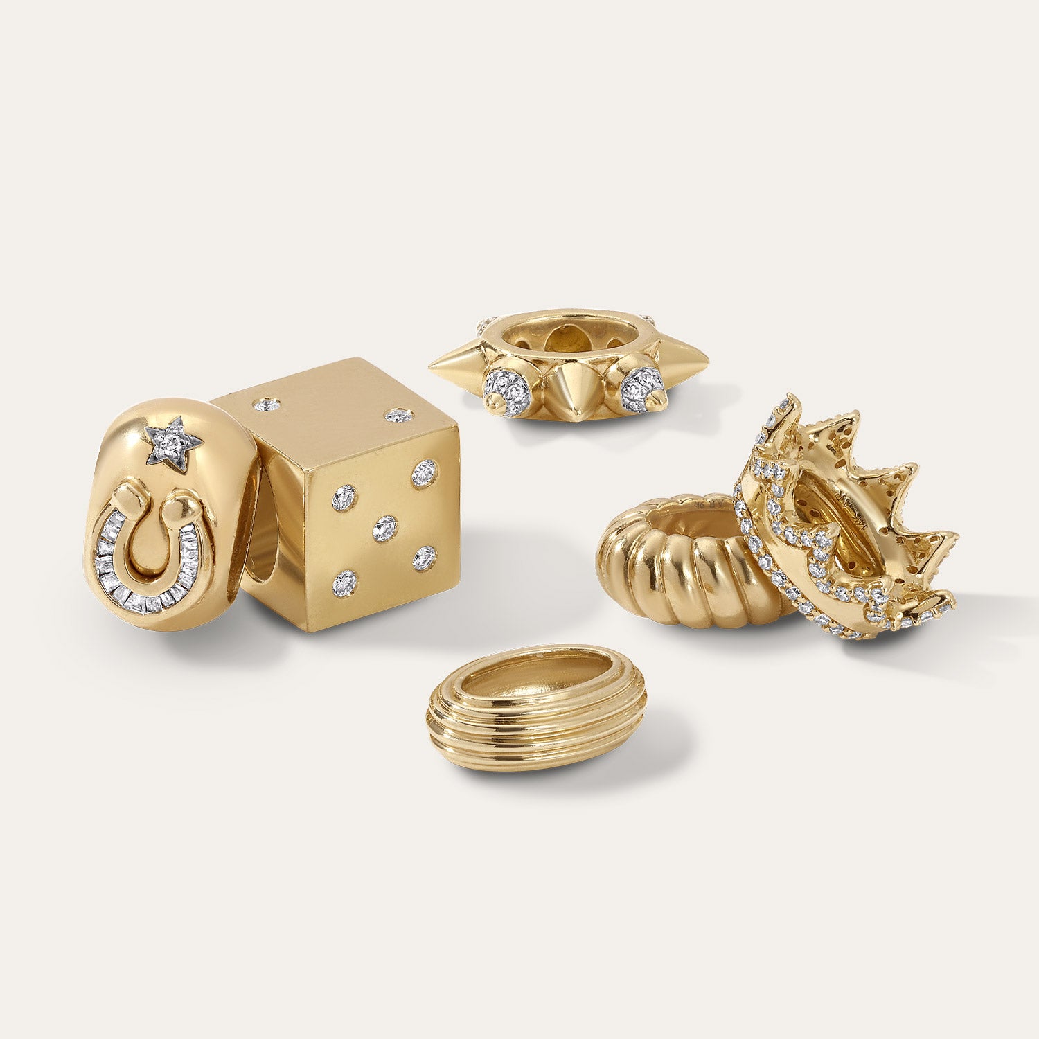 Gold big beads with various designs with diamonds on a white background